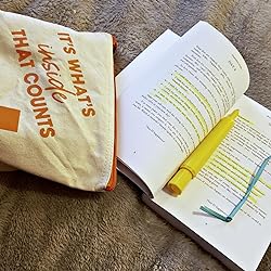 Close-up of the book’s textured cover featuring a cheerful yellow background and embossed gold title lettering