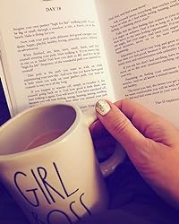 Close-up of the book's textured hardcover featuring embossed gold title and subtle linen pattern, showing detailed material