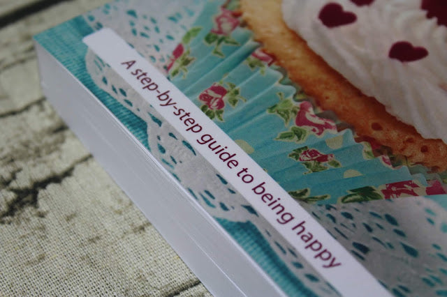 Close-up of the book’s textured cover featuring a gold-embossed title and vibrant yellow background, highlighting tactile