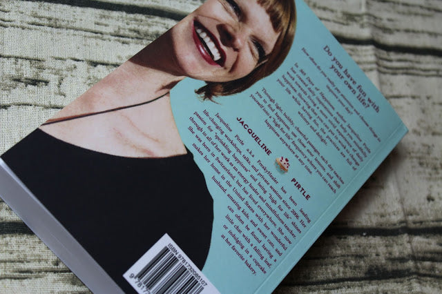 Close-up of the book’s textured cover featuring a vibrant yellow background and embossed title "365 Days of Happiness.